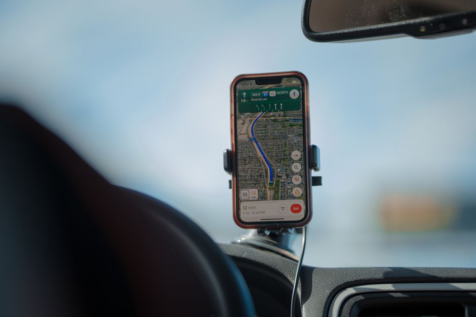 フロントガラスに取り付けたホルダーで地図アプリを表示したスマートフォン